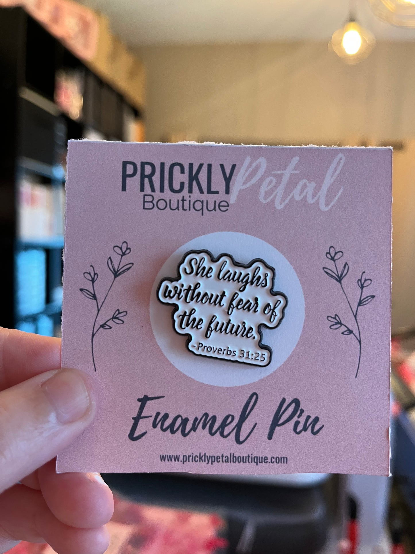 Enamel pin packaging with 'Prickly Petal Boutique' branding and a quote.