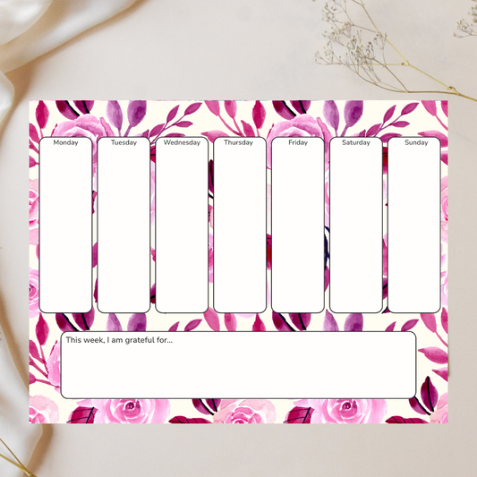 pink notepad with grateful wording against white background with flowers