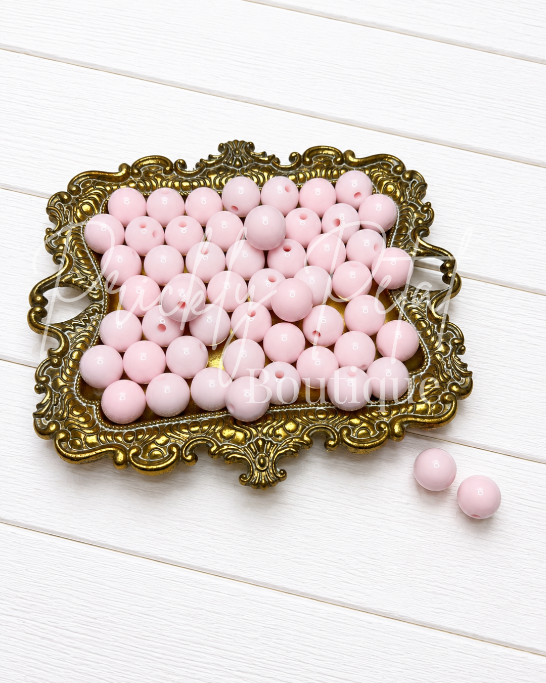 blush begonia round beads on gold tray