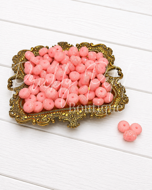 blush sparkle beads on gold tray against white wood