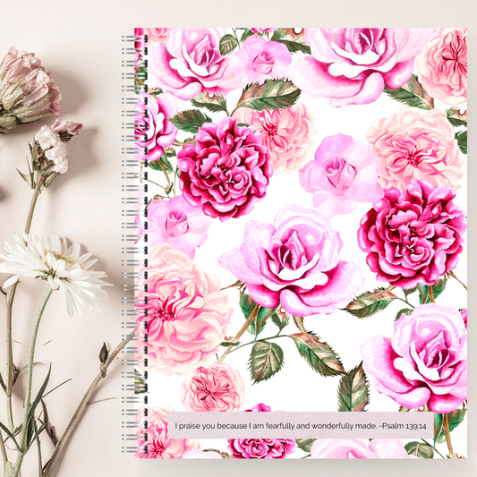 Notebook with pink floral design on a light background