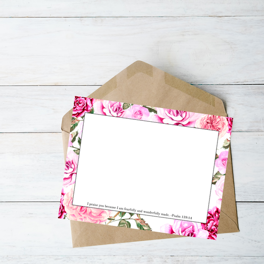 Floral card with pink roses and green leaves on a white background
