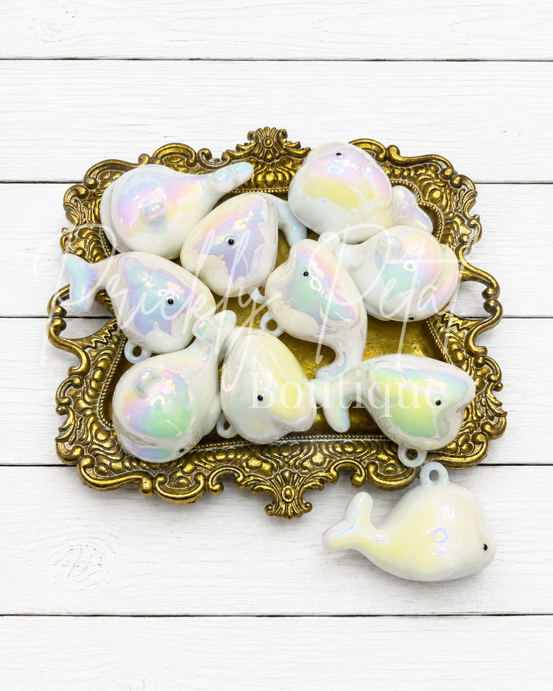 white whale charm on gold tray