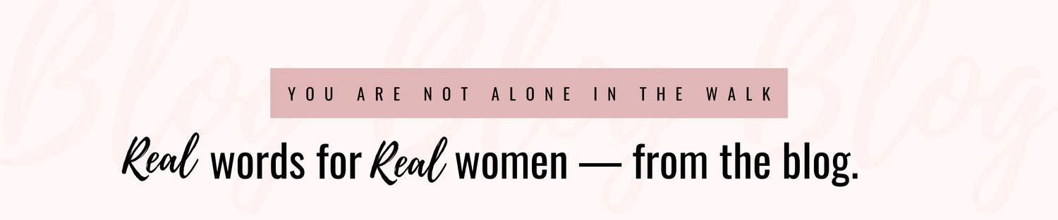 A text-based graphic with a pale pink background. A muted pink rectangular banner near the top reads 'YOU ARE NOT ALONE IN THE WALK' in black uppercase letters, and below it the phrase 'Real words for Real women — from the blog.