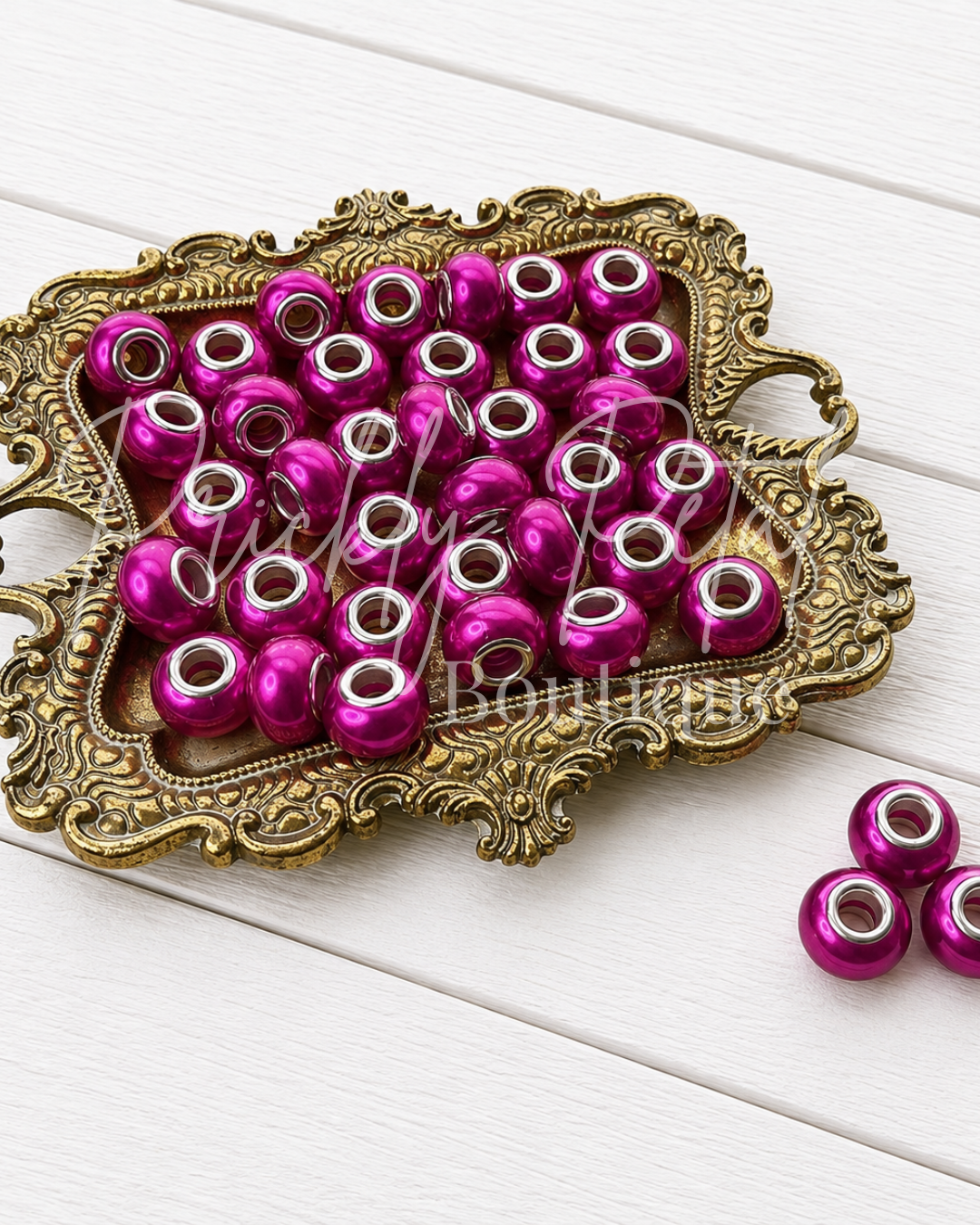 bead on gold tray against white background