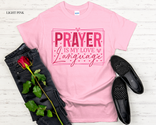 pink t shirt with design with black jeans and white background