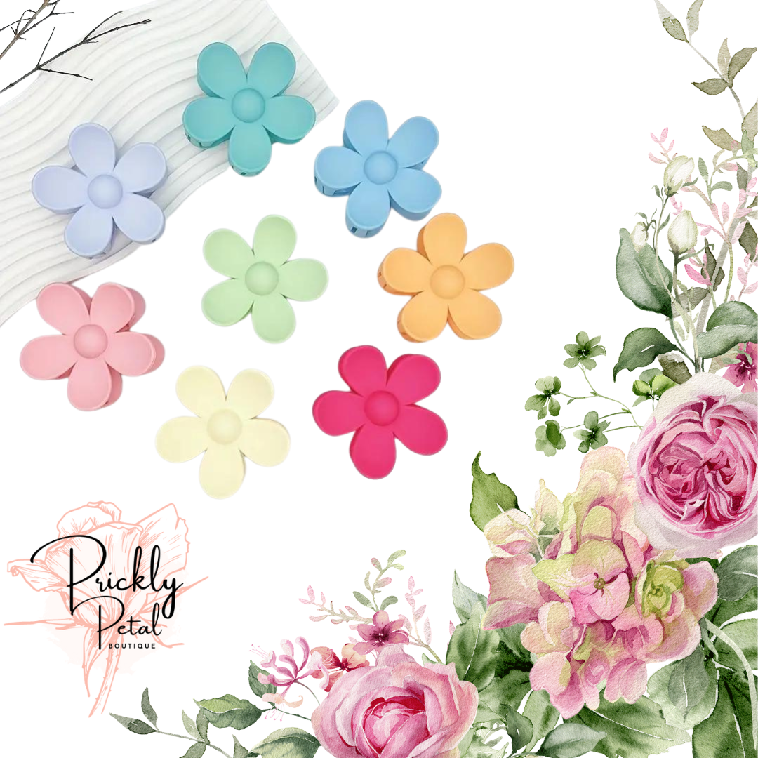 A collection of colorful flower-shaped hair clips displayed on a white background, with a logo at the bottom that reads 'Prickly Petal Boutique'.