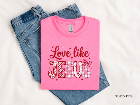 love like Jesus pink tshirt against bluejeans and white background